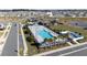 Aerial view of neighborhood pool with sun loungers and covered seating perfect for relaxing in the sun at 7223 Sw 61St Pl, Ocala, FL 34474