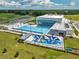 Aerial view of the community aquatic center with pools, splashpad, and lounge seating at 7223 Sw 61St Pl, Ocala, FL 34474