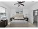 Bright bedroom featuring a ceiling fan and ensuite bathroom with glass shower at 7223 Sw 61St Pl, Ocala, FL 34474