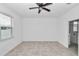 This is a spacious bedroom that includes a ceiling fan and ensuite bathroom at 7223 Sw 61St Pl, Ocala, FL 34474