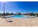 Large, inviting community pool surrounded by lounge chairs, umbrellas, and palm trees, perfect for relaxation and recreation at 7223 Sw 61St Pl, Ocala, FL 34474