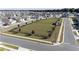 Aerial view of a community dog park lined with trees and complete with gazebo, surrounded by neighborhood homes at 7223 Sw 61St Pl, Ocala, FL 34474