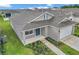 Inviting single-story home with a cozy front porch, landscaping and a two car garage at 7223 Sw 61St Pl, Ocala, FL 34474