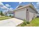 Side view of a well-kept two-car garage on a single-story home with a clean concrete driveway at 7223 Sw 61St Pl, Ocala, FL 34474