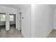 Bright hallway with tile flooring leading to bedrooms, creating an inviting and spacious atmosphere at 7223 Sw 61St Pl, Ocala, FL 34474