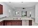 Kitchen with granite countertops and stainless steel dishwasher overlooks living area at 7223 Sw 61St Pl, Ocala, FL 34474