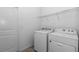 Well-equipped laundry room featuring a washer and dryer and ample shelving for storage convenience at 7223 Sw 61St Pl, Ocala, FL 34474