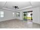 Living room with tile flooring, ceiling fan, and sliding glass doors at 7223 Sw 61St Pl, Ocala, FL 34474