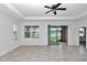 Bright living room featuring tile floors, a ceiling fan, and sliding glass doors to the outdoor patio at 7223 Sw 61St Pl, Ocala, FL 34474