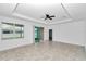 Spacious living room has tile floors, ceiling fan, and sliding glass doors at 7223 Sw 61St Pl, Ocala, FL 34474