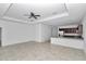 Open floor plan with living area and kitchen featuring tile floors and ceiling fan at 7223 Sw 61St Pl, Ocala, FL 34474