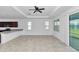 Open living space with tile floors and view of kitchen and sliding glass doors at 7223 Sw 61St Pl, Ocala, FL 34474