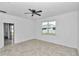 The main bedroom has light neutral walls, a ceiling fan, and a window that allows light to enter the room at 7223 Sw 61St Pl, Ocala, FL 34474