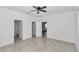 The bedroom features neutral walls, a tile floor, and multiple doorway access points to other rooms at 7223 Sw 61St Pl, Ocala, FL 34474