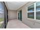 Screened patio features concrete flooring, shielding from the elements, with an easy access sliding glass door to inside at 7223 Sw 61St Pl, Ocala, FL 34474