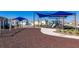 Community playground area with swings, a play structure, mulch ground cover, and sidewalk; great for outdoor enjoyment at 7223 Sw 61St Pl, Ocala, FL 34474