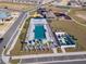 Aerial view of a beautiful swimming pool with ample seating and a splashpad nearby at 7223 Sw 61St Pl, Ocala, FL 34474