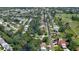 An aerial view of the house that is near the road with a small lake and residential homes around it at 798 Fairway Dr, New Smyrna Beach, FL 32168