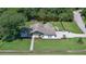 Beautiful single-story home featuring an expansive, well-maintained lawn and attractive landscaping near a tranquil pond at 798 Fairway Dr, New Smyrna Beach, FL 32168