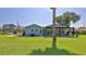 Well-maintained backyard with a patio, seating area, and lush green lawn perfect for outdoor living at 798 Fairway Dr, New Smyrna Beach, FL 32168