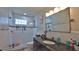 Well-lit bathroom with a glass-enclosed shower, granite countertop, and modern fixtures at 798 Fairway Dr, New Smyrna Beach, FL 32168