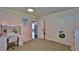 Bright bedroom featuring plush carpet, ample closet space, and natural light at 798 Fairway Dr, New Smyrna Beach, FL 32168