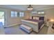 Bright bedroom features a plush bed, plantation shutters, and neutral colors for a peaceful and airy feel at 798 Fairway Dr, New Smyrna Beach, FL 32168