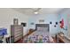 Well-lit bedroom with ceiling fan, dark hardwood floors and natural light at 798 Fairway Dr, New Smyrna Beach, FL 32168