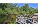 Wooden dock on the waterfront, featuring seating and serene views of the water at 798 Fairway Dr, New Smyrna Beach, FL 32168