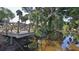 Dock overlooking calm waters, surrounded by lush vegetation, creating a peaceful retreat at 798 Fairway Dr, New Smyrna Beach, FL 32168