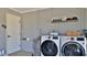 Bright laundry room with a modern washer and dryer, storage, and convenient utility features at 798 Fairway Dr, New Smyrna Beach, FL 32168