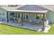 Outdoor patio with a seating area, grill and bar area perfect for entertaining guests at 798 Fairway Dr, New Smyrna Beach, FL 32168