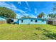 Nice backyard with well-maintained grass and a blue home at 903 Conrad Dr, New Smyrna Beach, FL 32168