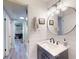 Bathroom features a vanity with marble countertop and stylish vanity lighting at 903 Conrad Dr, New Smyrna Beach, FL 32168