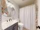Bathroom features a vanity with marble countertop and a shower with a white curtain at 903 Conrad Dr, New Smyrna Beach, FL 32168