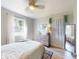 Bright bedroom with a ceiling fan, window, and a full-length mirror at 903 Conrad Dr, New Smyrna Beach, FL 32168