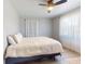 Cozy bedroom featuring a ceiling fan and natural light from the large window at 903 Conrad Dr, New Smyrna Beach, FL 32168