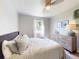 Bright bedroom features a bed, ceiling fan, window, and a wood dresser at 903 Conrad Dr, New Smyrna Beach, FL 32168