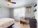 Bedroom features a ceiling fan, desk, and a light colored rug at 903 Conrad Dr, New Smyrna Beach, FL 32168