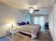 This bedroom features two beds, a ceiling fan, and a sliding glass door at 903 Conrad Dr, New Smyrna Beach, FL 32168