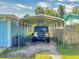 An open carport provides covered parking alongside the home, protecting vehicles from the elements at 903 Conrad Dr, New Smyrna Beach, FL 32168