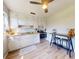 Functional kitchen with sleek appliances, bright white cabinets, a modern ceiling fan, and a casual dining area at 903 Conrad Dr, New Smyrna Beach, FL 32168