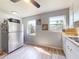 Kitchen featuring stainless steel refrigerator, modern appliances, light wood floors, and bright windows at 903 Conrad Dr, New Smyrna Beach, FL 32168