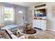 Cozy living room with couch, decorative accents, light wood floors, bright windows and neutral paint at 903 Conrad Dr, New Smyrna Beach, FL 32168