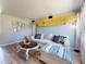 Bright living room featuring a surfboard accent, comfortable couch, and light wood floors at 903 Conrad Dr, New Smyrna Beach, FL 32168