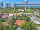 A neighborhood aerial view featuring water tower, local businesses, verdant landscaping, and distant waterfront scenery at 934 N Halifax Ave, Daytona Beach, FL 32118