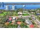 A neighborhood aerial view showcasing surrounding streets, water tower, landscaping, and distant waterfront scenery at 934 N Halifax Ave, Daytona Beach, FL 32118