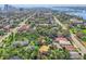 A neighborhood aerial shot featuring verdant trees, local roadways, and the distant waterway beyond at 934 N Halifax Ave, Daytona Beach, FL 32118