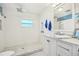 Bright bathroom features all-white tiling, a shower, and a marble-top sink at 934 N Halifax Ave, Daytona Beach, FL 32118