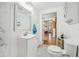 Clean bathroom featuring a modern vanity, toilet, and decorative shelves at 934 N Halifax Ave, Daytona Beach, FL 32118